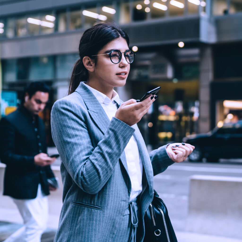 A woman using a smartphone on the street.