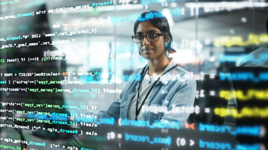 : A female programmer working on a computer at the office. 