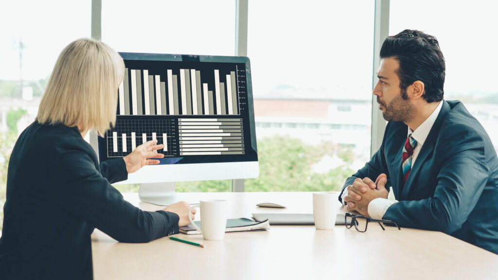 A female professional explaining the statistical information to her colleague. 