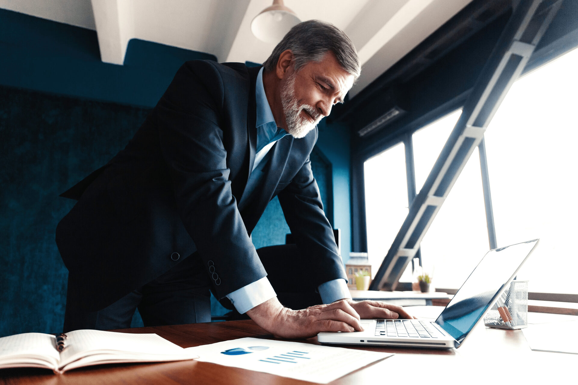 A businessman working on a laptop.